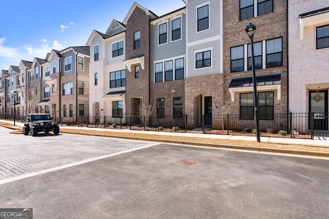 view of property featuring a residential view and fence