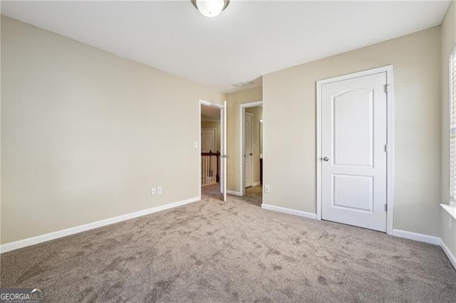 unfurnished bedroom featuring carpet floors and baseboards