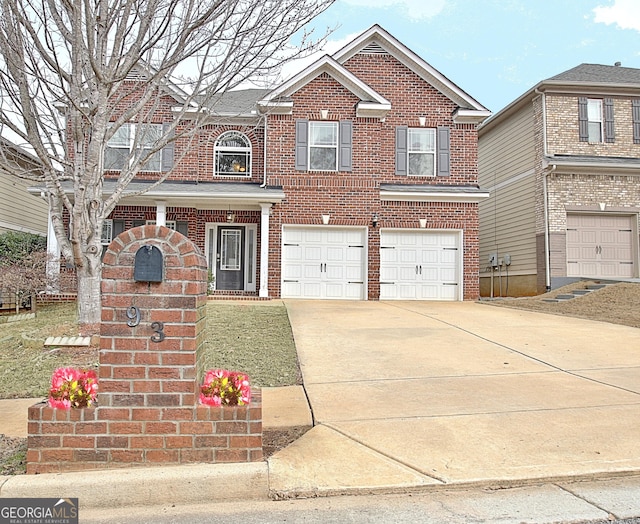 view of front of property with concrete driveway, brick siding, and an attached garage