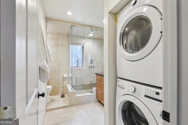 laundry area with light tile patterned floors, laundry area, stacked washer / dryer, and recessed lighting