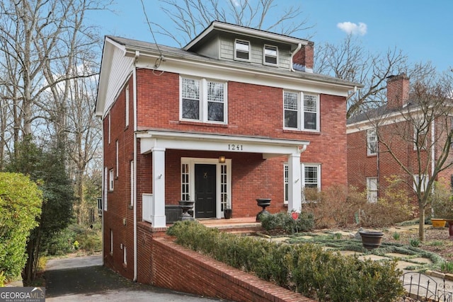 view of front of property with covered porch and brick siding