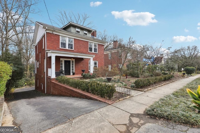 american foursquare style home with brick siding