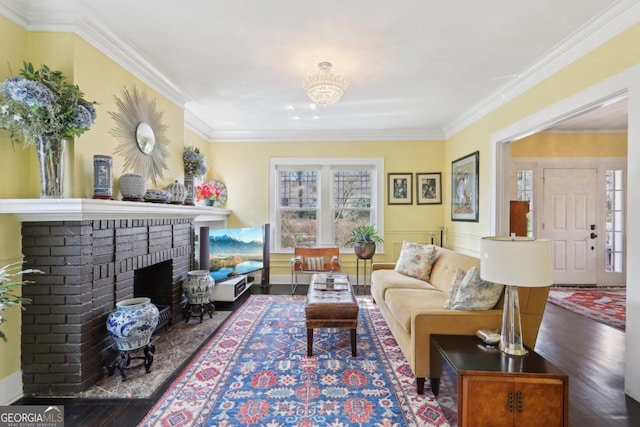 living area with dark wood-style flooring, a brick fireplace, and crown molding