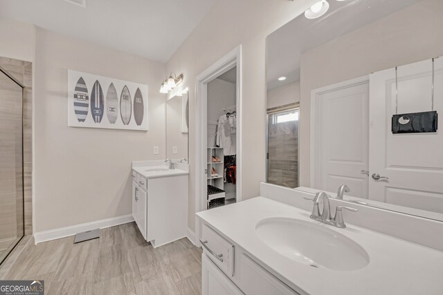 6441 SE Brookside Blvd, Mableton, GA 30126 - full bathroom featuring two vanities, a sink, a spacious closet, and a shower stall
