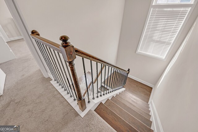6441 SE Brookside Blvd, Mableton, GA 30126 - stairs with carpet floors, wood finished floors, and baseboards
