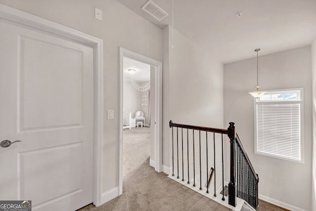 6441 SE Brookside Blvd, Mableton, GA 30126 - corridor with baseboards, visible vents, light carpet, and an upstairs landing