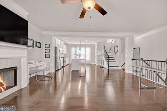 6441 SE Brookside Blvd, Mableton, GA 30126 - living room with baseboards, dark wood-style floors, a premium fireplace, ornamental molding, and stairway