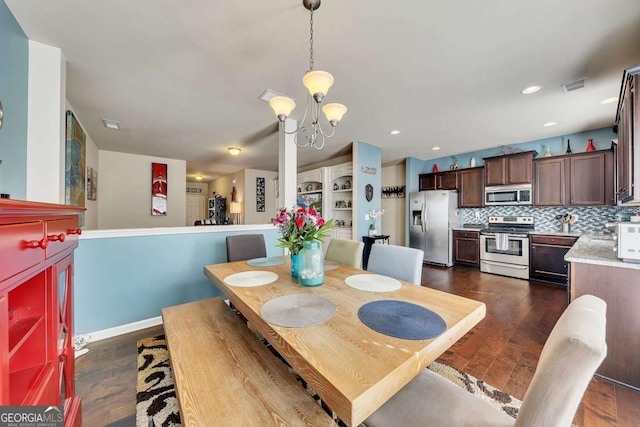 dining area with recessed lighting, visible vents, baseboards, dark wood finished floors, and an inviting chandelier