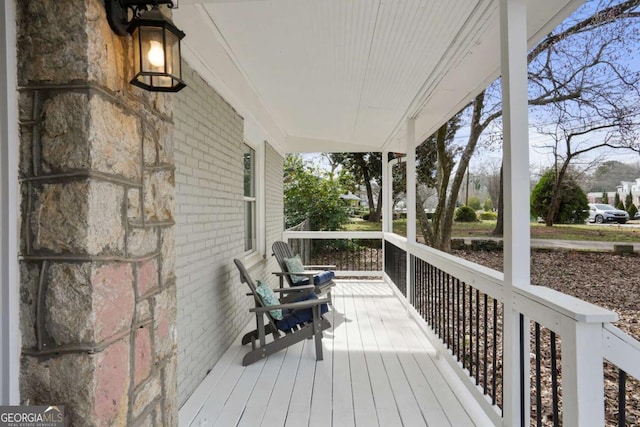 wooden terrace featuring a porch