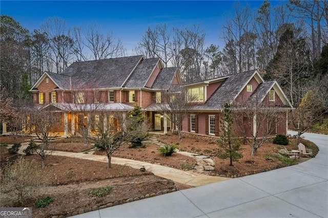 view of front of property featuring driveway and brick siding