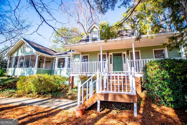 view of front of property with a sunroom and a porch