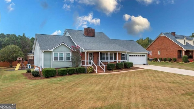 view of front of property featuring a front yard, concrete driveway, a playground, and brick siding