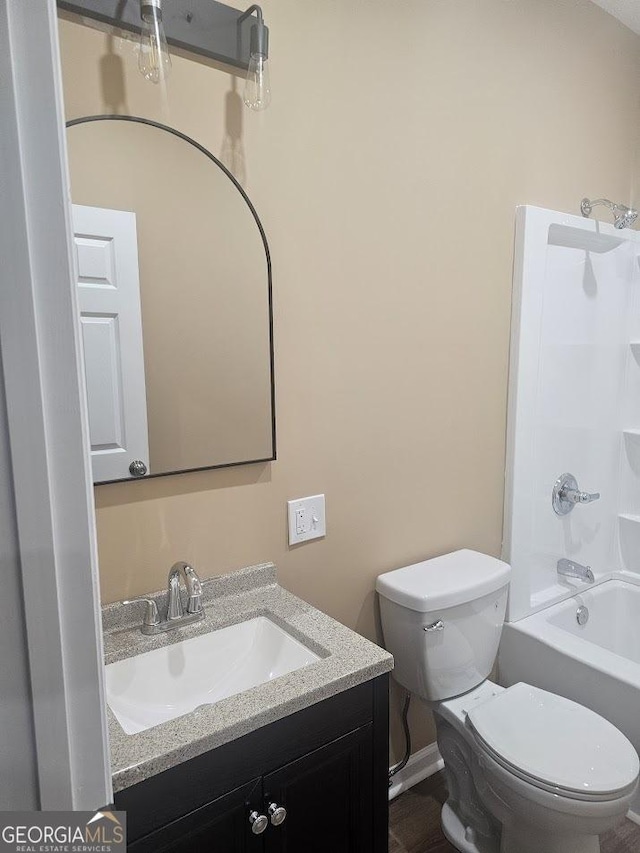 full bath with toilet, shower / washtub combination, and vanity
