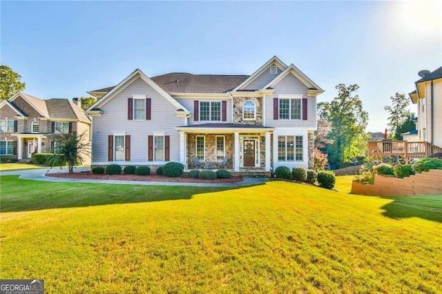 view of front facade featuring stone siding and a front lawn