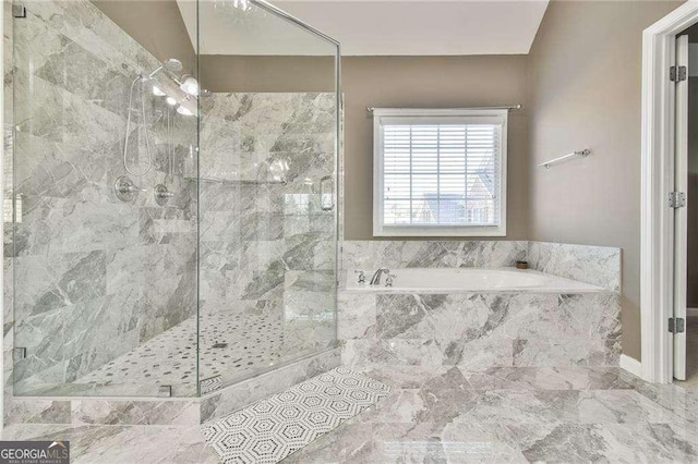 bathroom with a shower stall and a bath