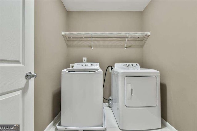 laundry room featuring laundry area, washer and clothes dryer, and baseboards