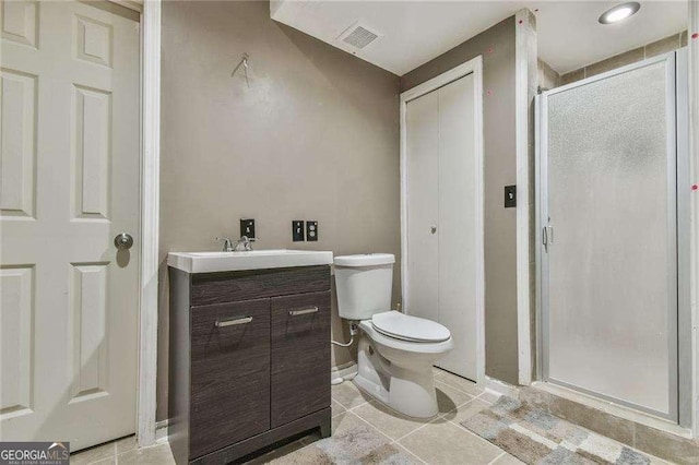 full bathroom featuring a stall shower, visible vents, toilet, tile patterned flooring, and vanity