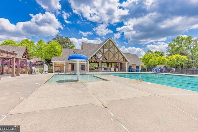 pool with fence and a patio