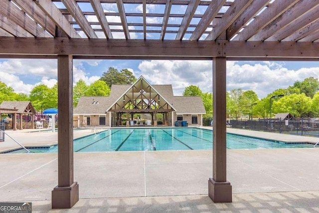 community pool with a patio, a gazebo, fence, and a pergola