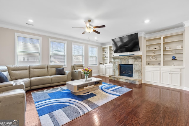 living area with plenty of natural light, ornamental molding, and dark wood finished floors