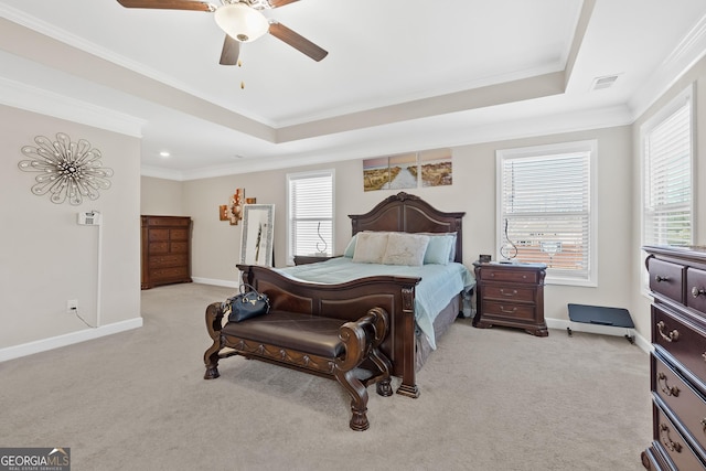 bedroom with light colored carpet, a raised ceiling, visible vents, and multiple windows