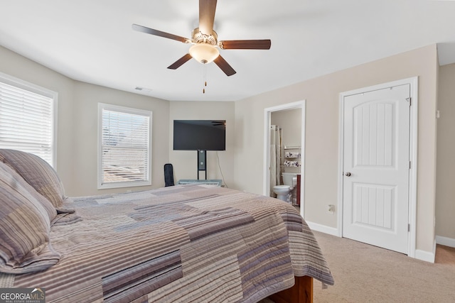 bedroom featuring visible vents, a ceiling fan, light carpet, connected bathroom, and baseboards