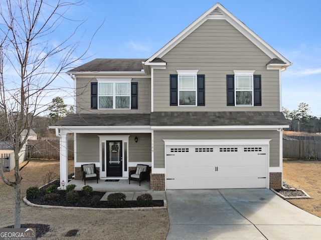 view of front of property with covered porch, a garage, brick siding, fence, and concrete driveway