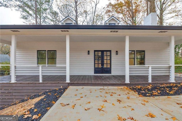 view of exterior entry featuring a porch