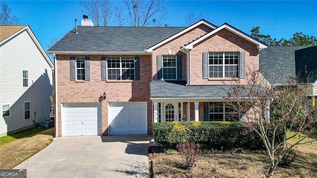 view of front of home featuring a garage, brick siding, driveway, and a chimney