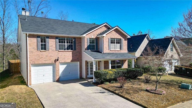 view of front of property with an attached garage, brick siding, driveway, a chimney, and a front yard