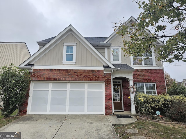 view of front of property with board and batten siding, concrete driveway, brick siding, and a shingled roof