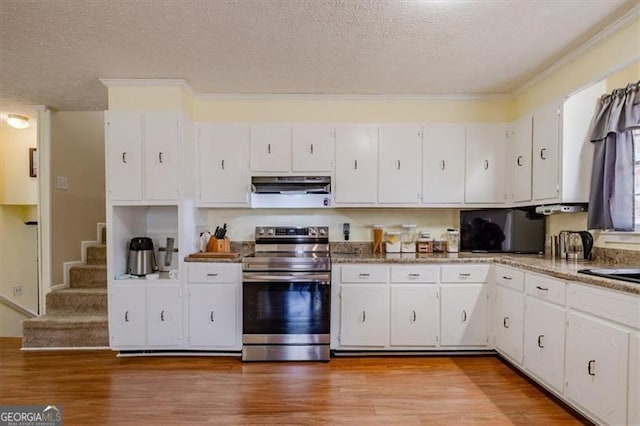 kitchen with a textured ceiling, under cabinet range hood, light wood-style floors, white cabinets, and stainless steel electric range oven