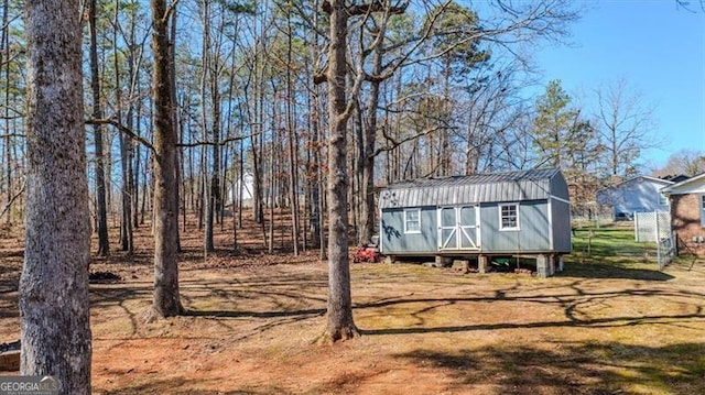 exterior space with a shed and an outbuilding