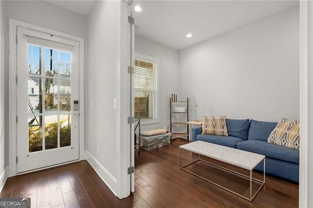 interior space featuring a healthy amount of sunlight, baseboards, dark wood finished floors, and recessed lighting