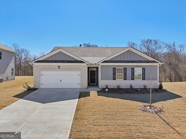 single story home with concrete driveway, brick siding, board and batten siding, and an attached garage