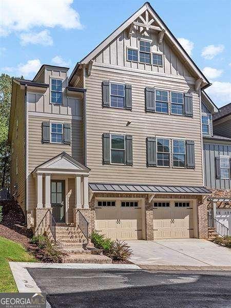 view of front of home with a garage, driveway, and board and batten siding