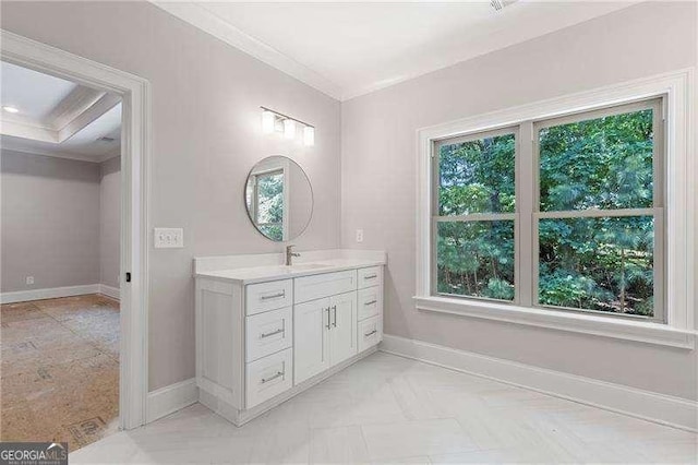 bathroom featuring ornamental molding, a wealth of natural light, and baseboards