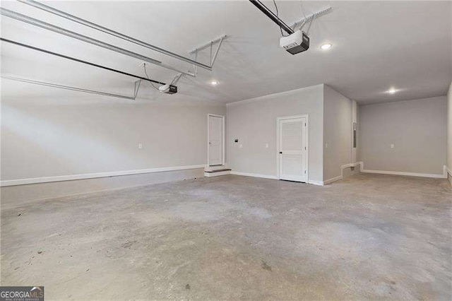 garage with a garage door opener and baseboards