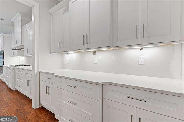 kitchen featuring dark wood-style floors, white cabinetry, and tasteful backsplash