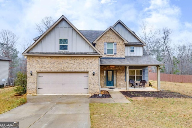 view of front facade featuring a garage, concrete driveway, a porch, board and batten siding, and brick siding