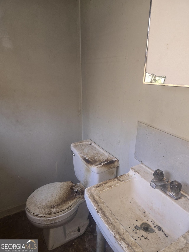 half bathroom with a sink and toilet