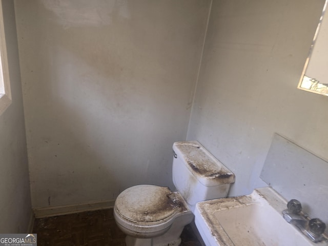 half bathroom featuring toilet