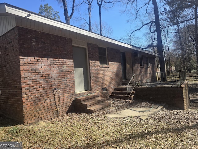 exterior space with crawl space and brick siding