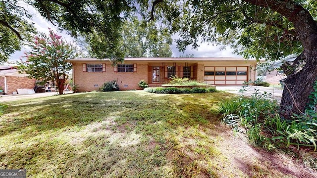 single story home with an attached garage, brick siding, driveway, crawl space, and a front lawn