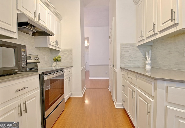 kitchen with stainless steel range with electric stovetop, white cabinets, light countertops, and under cabinet range hood