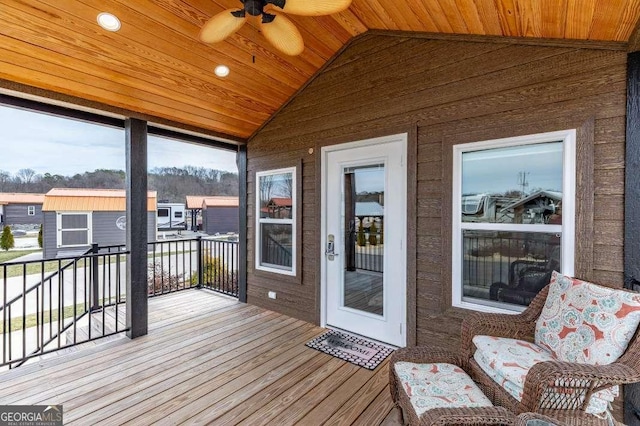 wooden terrace with a ceiling fan