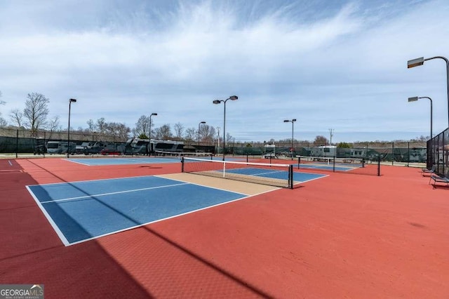 view of tennis court featuring fence