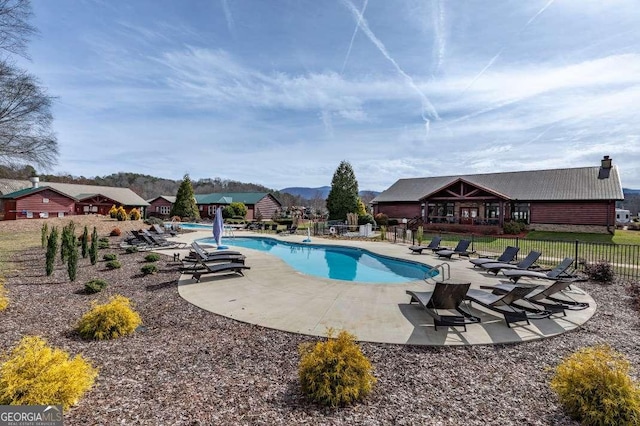 pool featuring a patio area and fence