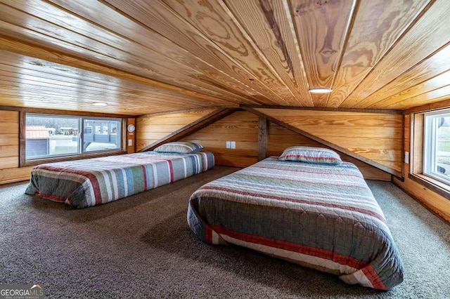 bedroom featuring wood walls, wooden ceiling, and carpet flooring