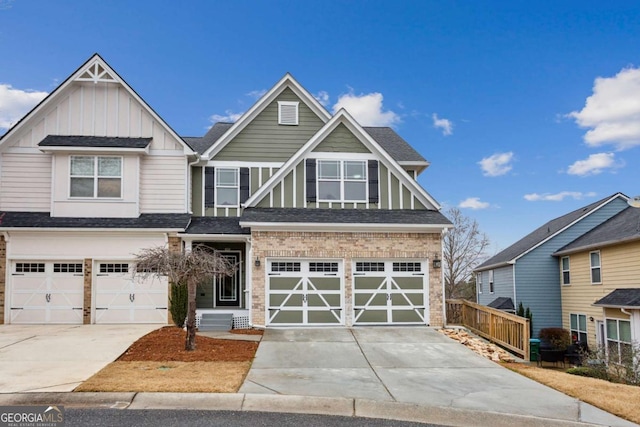 craftsman-style home with board and batten siding, brick siding, driveway, and an attached garage